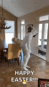 a person in a white bunny suit is dancing in a living room .