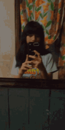a person is taking a picture of themselves in a mirror while wearing a shirt that says hot