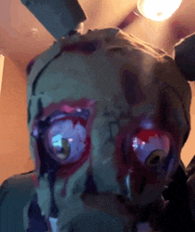 a close up of a person 's face with a green mask on