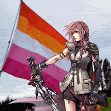 a woman holding a sword in front of a flag