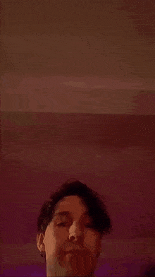 a close up of a person 's face with a blurred background .