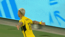 a soccer player wearing a yellow jersey with the number 17