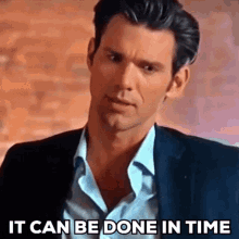 a man in a suit and white shirt is saying it can be done in time .