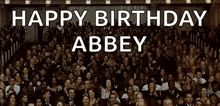 a large group of people are gathered in a room with the words happy birthday abbey written in white letters