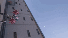 a robot with spikes on its head is standing in front of a tall building