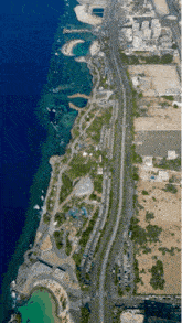 an aerial view of a park along the shoreline of the ocean