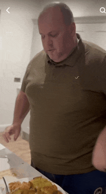 a man in a polo shirt with the letter v on the front