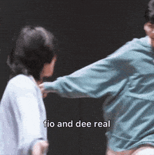 a man and a woman are fighting with the words fio and dee real in the background