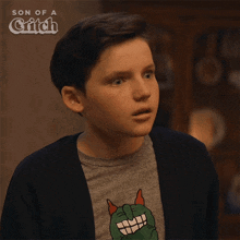 a boy wearing a shirt that says son of a griffin
