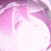 a close up of a pink and white balloon