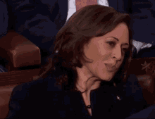 a woman sitting in a chair with a gold star on the arm rest