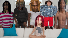 a group of people including a little girl with red hair and a man with dreadlocks