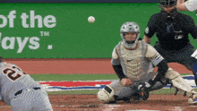 a baseball game is being played in front of a sign that says tm of the days