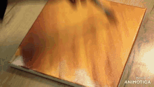 a person is painting a picture on a canvas .