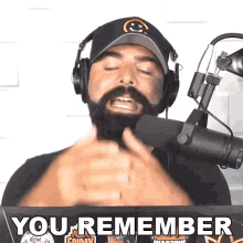 a man with a beard wearing headphones says you remember