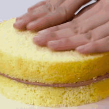 a close up of someone 's hands on a cake