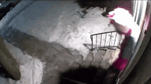 a person in a santa hat is walking down a snowy sidewalk
