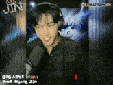 a young man wearing headphones is smiling in front of a microphone with the words big love written on the bottom right