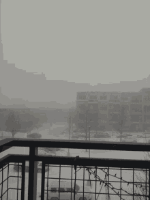 a black and white photo of a snowy city street