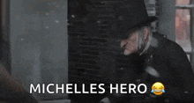 a man in a top hat is standing in front of a window with the words michelles hero below him