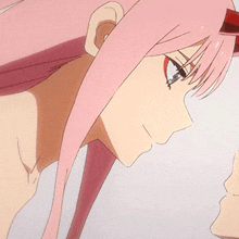 a close up of a person 's face with pink hair and a white hat .
