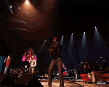 a group of people singing on a stage with the words rbd_gif on the bottom right