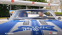 a man and a woman are driving a car that says sonic on the hood