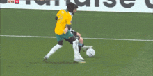 a group of soccer players on a field with one wearing a yellow jersey with the number 21 on it .