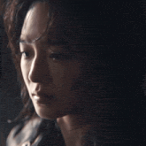 a close up of a woman 's face with her eyes closed
