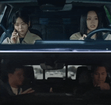 two women are sitting in a car with a man