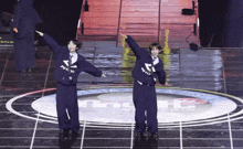 two people are dancing on a stage and one of their sweatshirts says ahwf