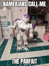 a figurine of a robot is standing on a table with a caption that says namekians call me the parfait