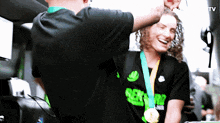 a person wearing a shirt that says rex on it is being congratulated by another person