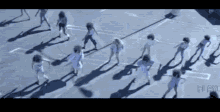 a group of cheerleaders are dancing in a parking lot .
