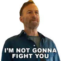 a man with a beard is wearing a blue shirt and says i 'm not gonna fight you