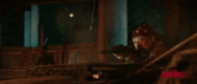 a man in a bandana is holding a gun in front of an explosion and the word brothers is on the bottom right