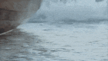 a close up of a person 's legs walking in the water