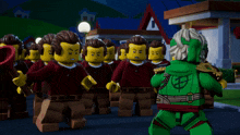 a group of lego figures standing in front of a building