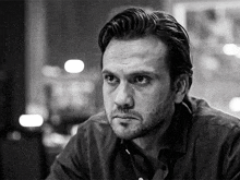a black and white photo of a man with a beard