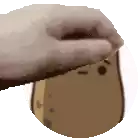a hand is holding a potato with a smiley face on it .