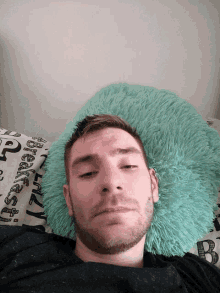 a man is laying on a bed with a pillow that says ' breakfast ' on it