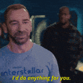 a man wearing a blue shirt that says interstellar says " i 'd do anything for you "