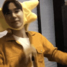 a person wearing a yellow jacket and a yellow hat