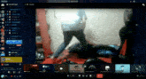 a computer screen displays a video of a man kicking another man in the face
