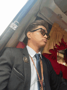a man wearing a suit and tie has a lanyard around his neck that says ' united nations '