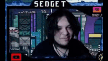 a man is sitting in front of a screen with the name sedget on it