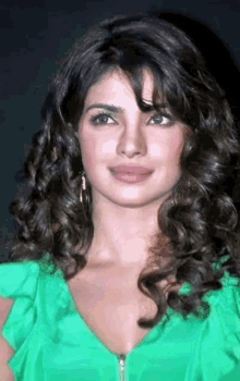 a close up of a woman 's face wearing a green top