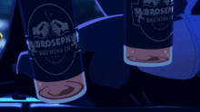 two bottles of brosephia brewing co. beer are sitting on a table