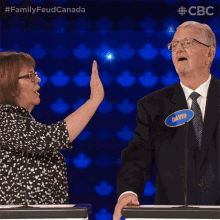 a woman giving a high five to a man whose name is david