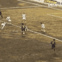 a group of soccer players are playing on a field with a sign that says ma fra on it